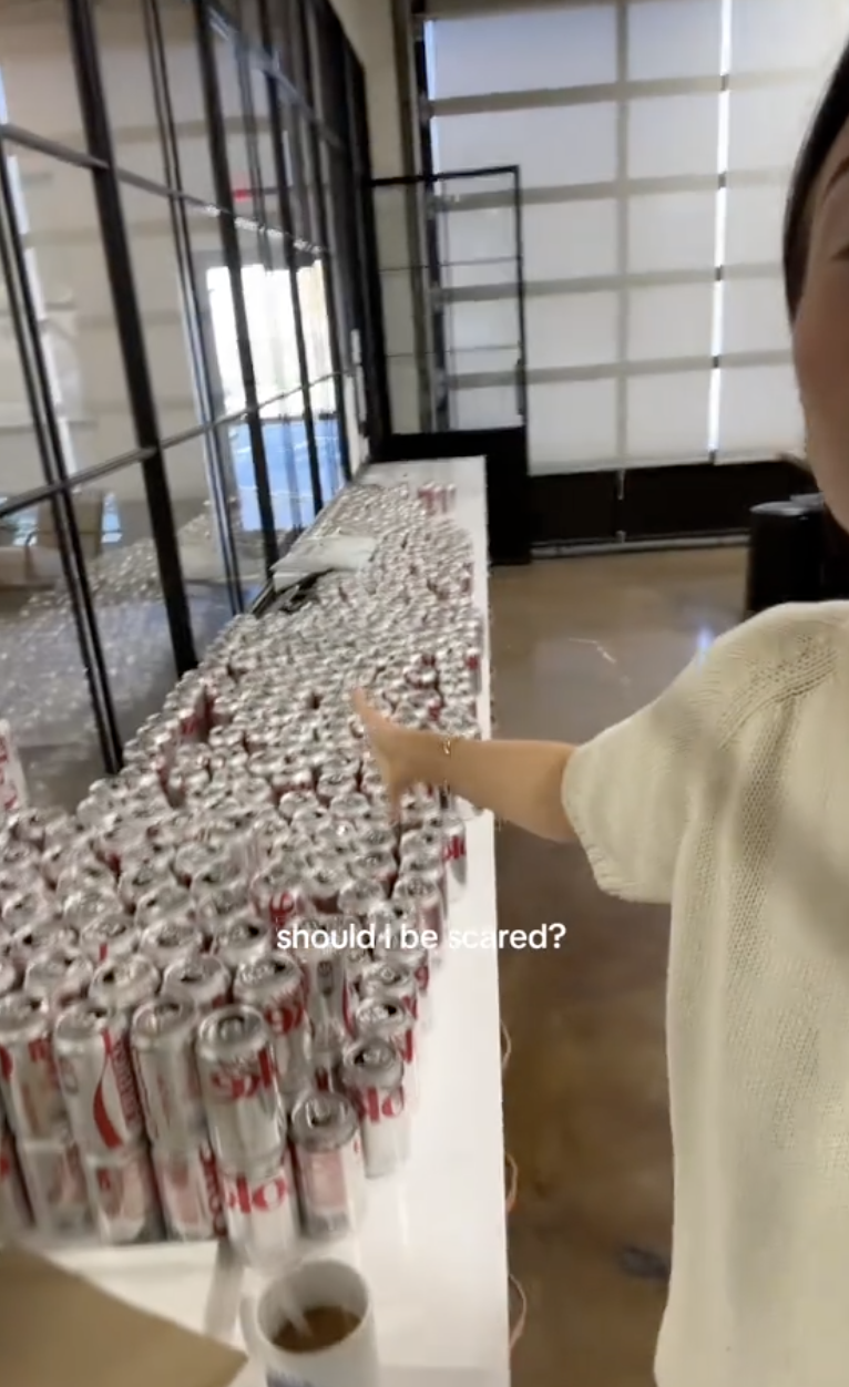 woman with diet coke cans